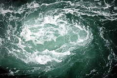 Ocean vortex or whirlpool.  Photograph of an ocean Whirlpool, or Vortex.  This icon represents Dam-Atolls vortex, which transfers energy to a turbine.  Title:  Water spiral.  ©JoeCollver; JoeCollver references a user id on Flickr.  Image used with his kind permission.  Flickr address:  http://www.flickr.com/photos/joecollver/43405323/; Flickr location:  http://farm1.static.flickr.com/25/43405323_869c05f64f_m.jpg